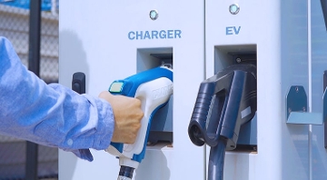 man at electric charging station